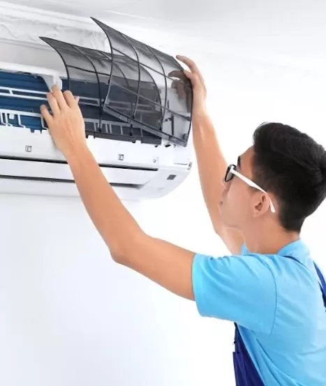 A man is installing an Ac