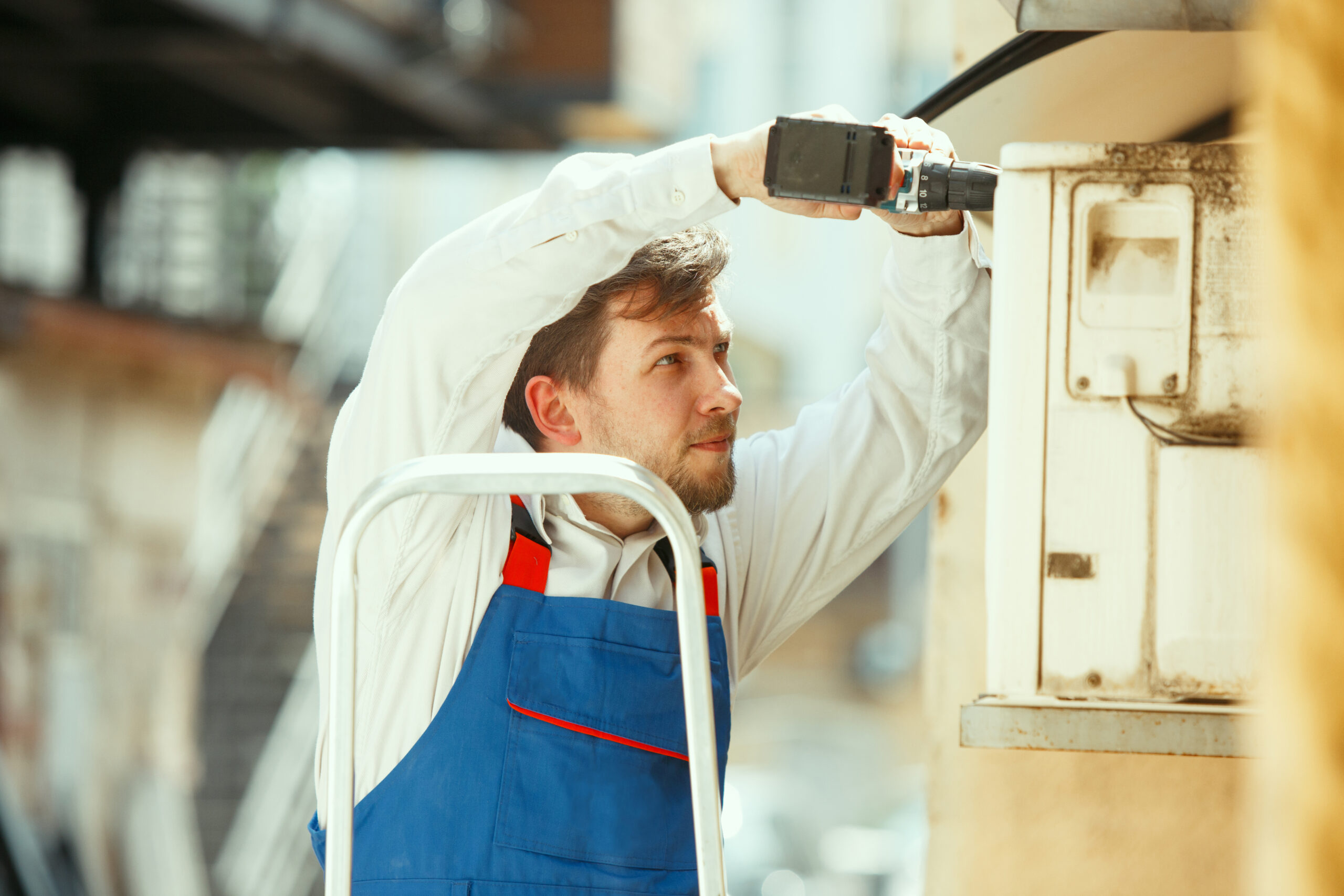 A man is fixing a ac